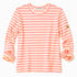 Flat lay of a Kerri Rosenthal pink and cream striped long sleeve crewneck top with a small gold heart emblem on the sleeve.