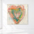 Love in Soft Focus, an original heart painting in coral, orange, and teal on a cream canvas, on a white wall.