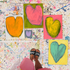 Bird's-eye view of Kerri in her studio, with some of her heart art at her feet.