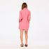 Back of women's pink and orange striped oversized button-down shirt and shorts set.