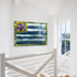 Abstract flag painting on a white wall with a staircase and window in the background