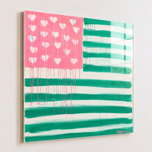 Kerri Rosenthal Heart-Flag painting in pink and green: an American flag design with a pink star field filled with white dripping hearts and teal-green and white painted stripes framed in plexi.