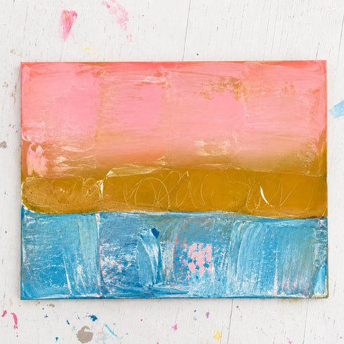Postcard from the Pacific Coast original painting with a pink sky, golden shoreline, and turquoise water in a table