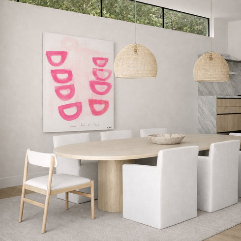 Modern dining room with a round wooden table, white chairs, and abstract pink artwork on the wall by Kerri Rosenthal.