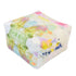 A square floor pouf ottoman with a white base covered in a colorful abstract watercolor paint pattern featuring green, pink, yellow, blue, and purple hues, shown on a solid white background.