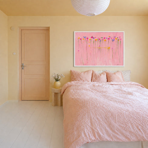 Kerri Rosenthal pink flower field painting in white frame above bed in pink and neutral bedroom