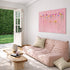 Kerri Rosenthal pink flower painting above blush velvet sofa in living room with garden view