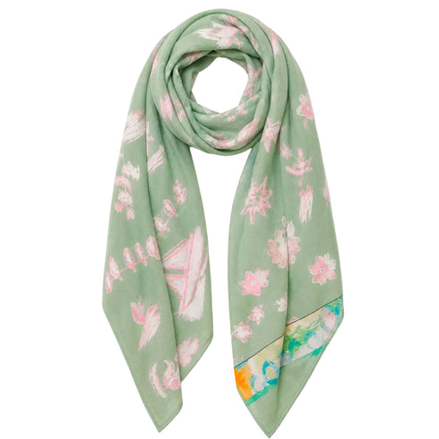 A sage green silk scarf with a pink floral pattern and a multicolor abstract border, displayed on a white background.