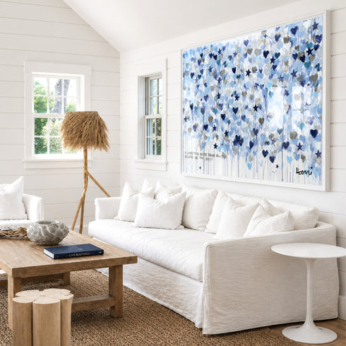 Starry Starry Love by Kerri Rosenthal — hand-painted hearts and stars in blue, navy, and grey in white frame in white living room.