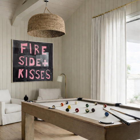 Kerri Rosenthal "Fireside + Kisses" original word art painting - pink hand-painted block letter text on black background canvas, framed in white, textured expressive brushstroke typography wall art for game room.