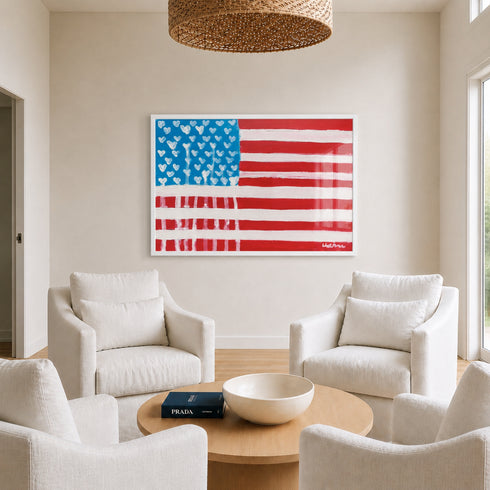 Living room with white furniture, a Prada book, and an American flag painting with Drippy Heart stars by Kerri Rosenthal