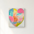 Kerri Rosenthal colorful abstract heart painting on canvas hanging on white wall