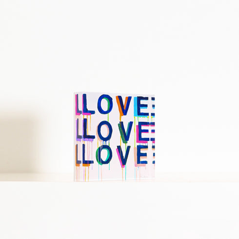 Love on Repeat Block of Love by Kerri Rosenthal. Blocks of Love are signed, mini editions of Kerri Rosenthal's word artwork mounted on 3/4" plexiglass acrylic block.