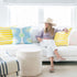 Colorful multi Seventeen cute square decorative throw pillows on couch by Kerri Rosenthal