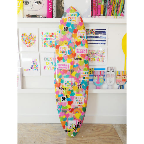 This colorful surfboard features expressive lettering and vibrant tones, perfect for surfing or home decor.