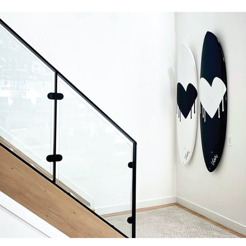 Handmade surfboard with bold heart art in black and white by Kerri Rosenthal