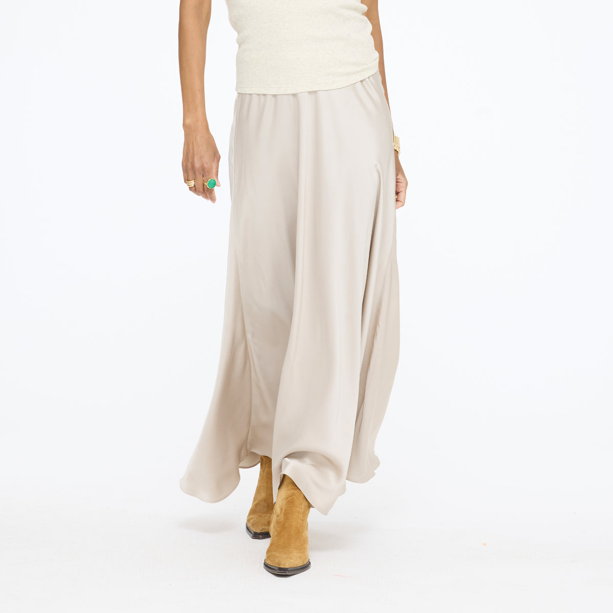 Model walking in the Ali Maxi Skirt in taupe with tan ankle boots, waist-down front view