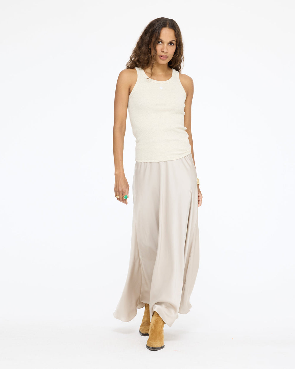 Model wearing the Ali Maxi Skirt in taupe with a white tank top, front view