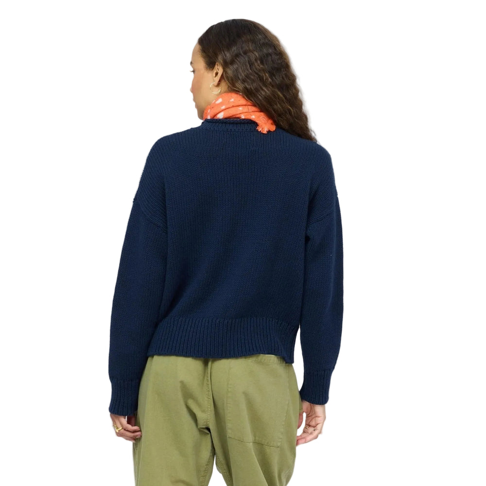 Kerri Rosenthal indigo roll neck sweater back view, styled with olive pants