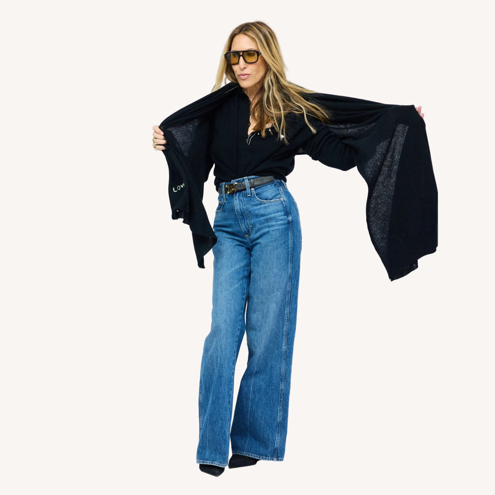 Kerri wearing Cashmere Wrap with contrast whipstitching along the edge and "loved" on the bottom hem