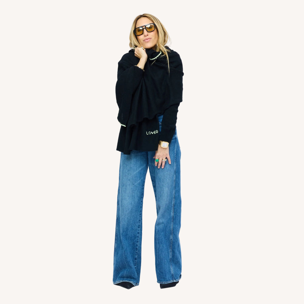 Kerri wearing Cashmere Wrap with contrast whipstitching along the edge and "loved" on the bottom hem, alternative view