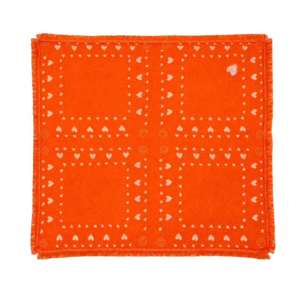 Kerri Rosenthal orange cashmere bandana flat lay showing full heart print pattern and fringe trim