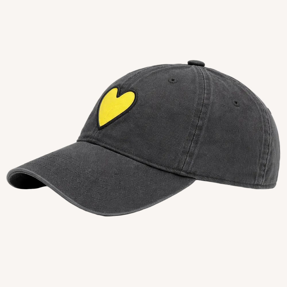 Side view of KR Imperfect heart coal baseball cap hat with yellow heart patch made from 100% cotton and adjustable strap - Shop heart baseball caps by Kerri Rosenthal