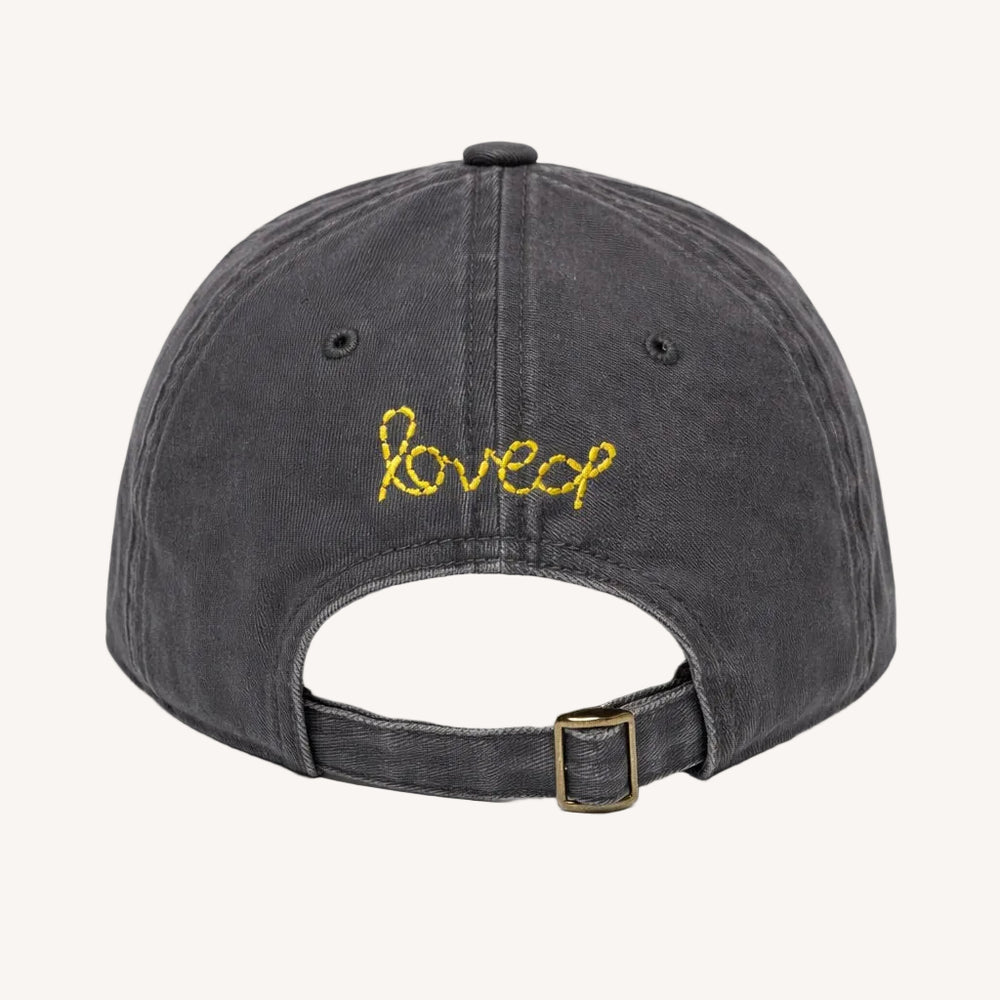 Back view of KR Imperfect heart coal baseball cap hat with yellow 'loved' embroidered on back made from 100% cotton and adjustable strap - Shop heart baseball caps by Kerri Rosenthal