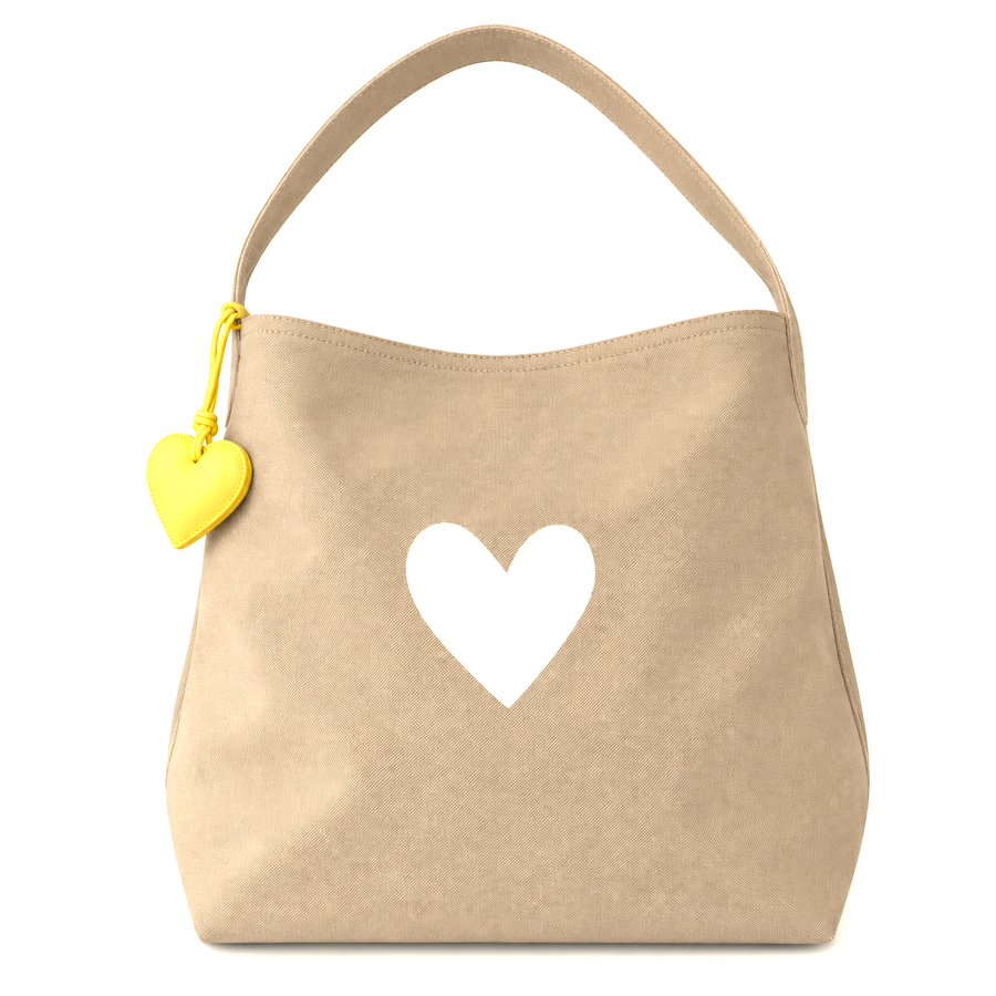 beige hobo bag with white heart on center.