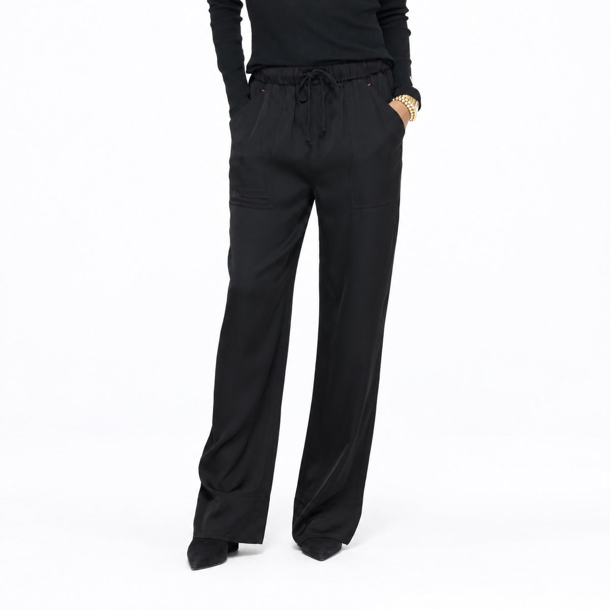Close-up of the Coast Pant in black with a drawstring waist, waist-down front view