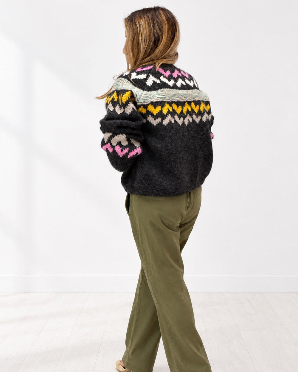 Kerri wearing the Sienna Ker-Isle Cardigan with olive pants, side view