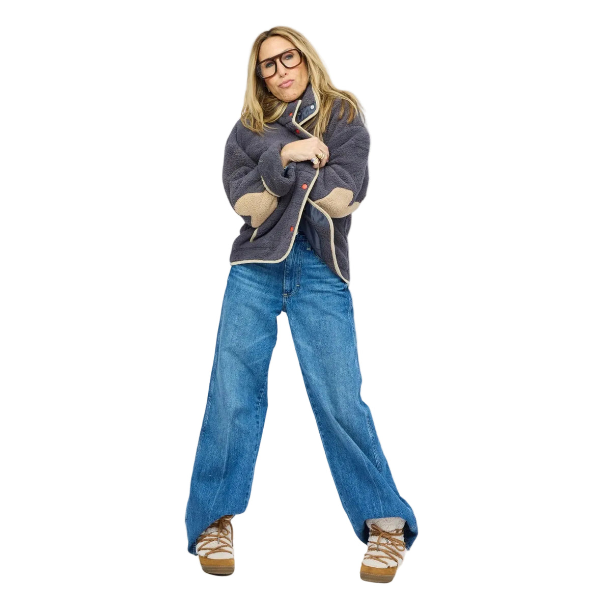 Model wearing gray sherpa jacket with cream contrast trim, snap-button front, and cuffed denim jeans