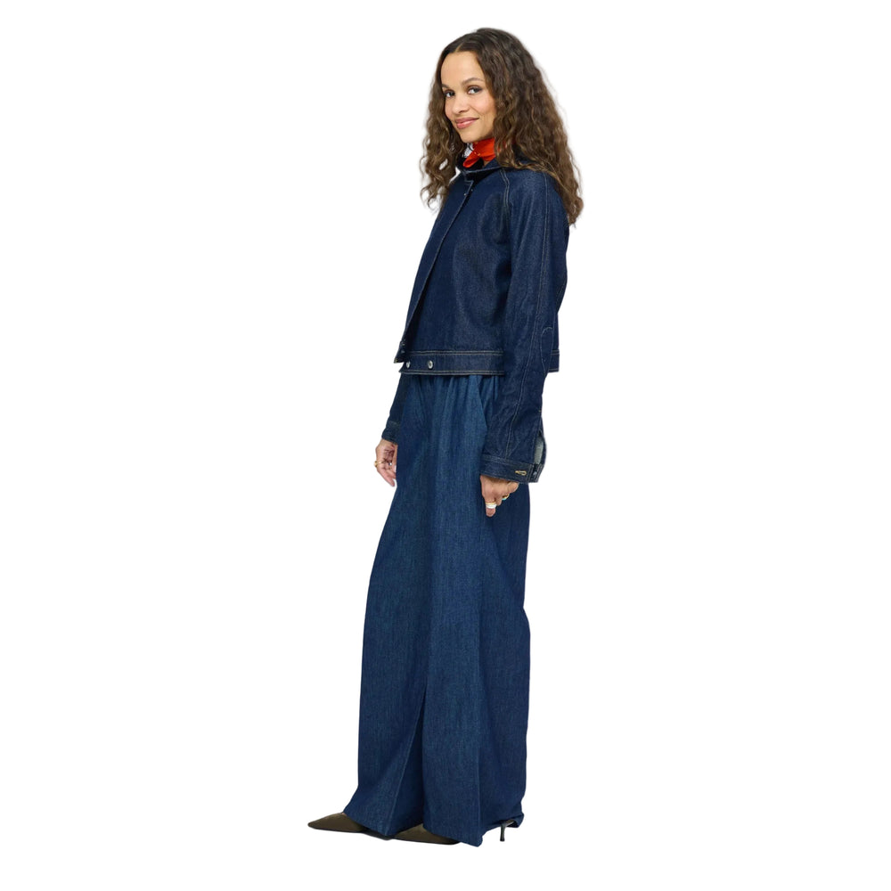Kerri Rosenthal cropped denim jacket and wide-leg denim trousers, side view styled with red neck scarf