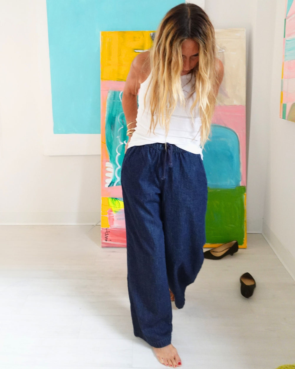 Kerri Rosenthal white tank front view styled with wide legged denim pants
