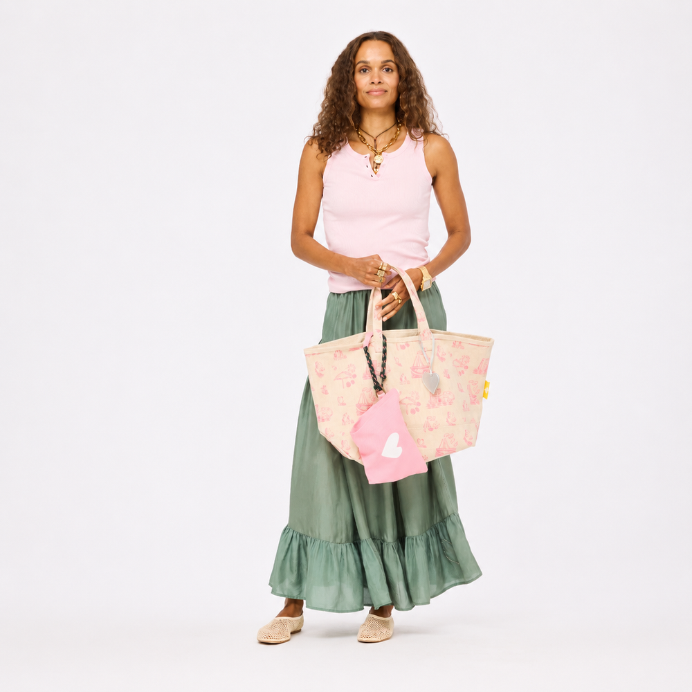 Women's flowy amalfi green tiered maxi skirt with pink tank and pink toile tote. Shop Kerri Rosenthal