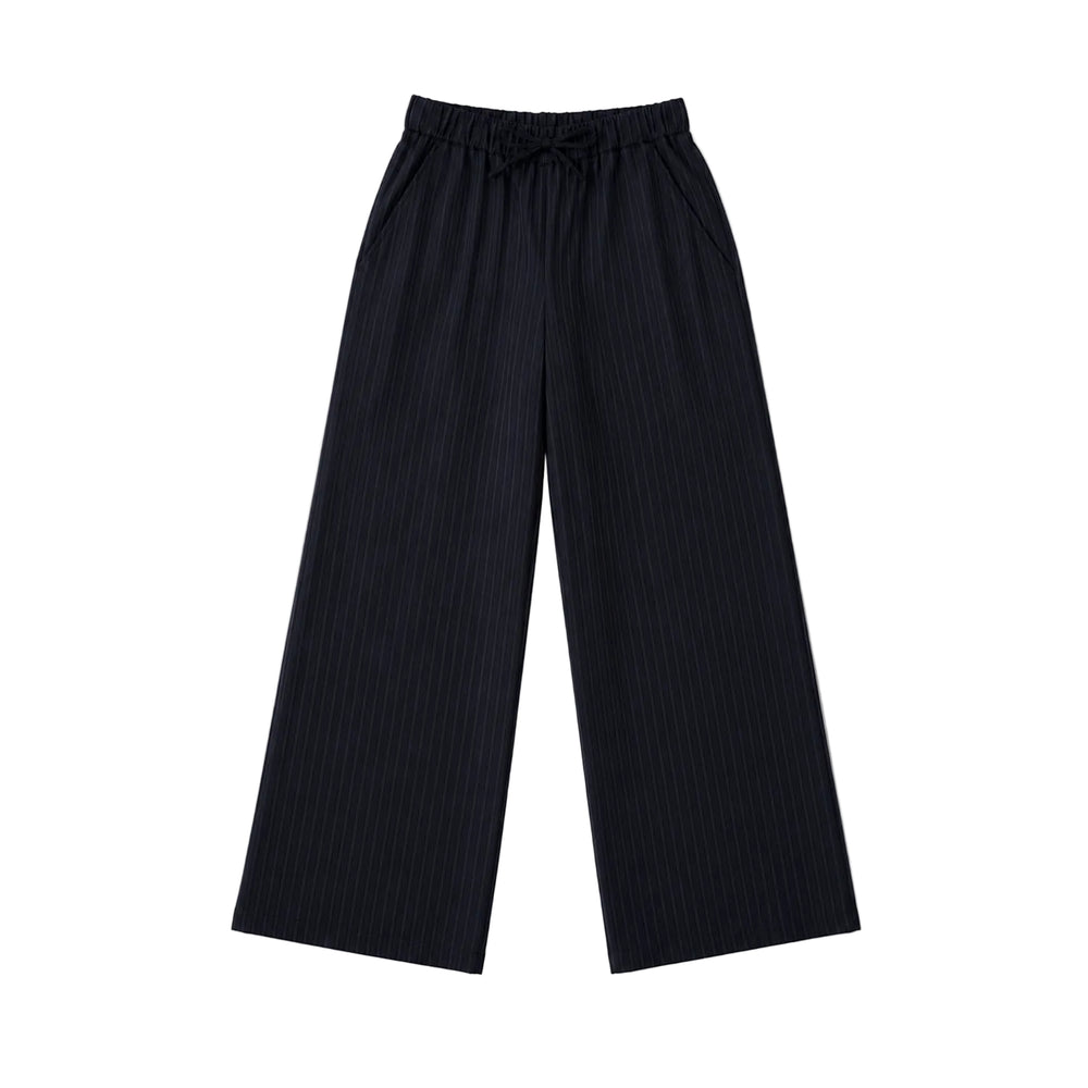Flat lay of black pinstripe pants.