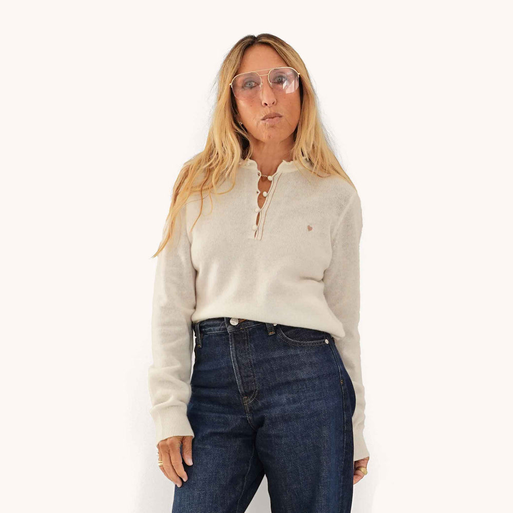 Kerri wearing Femme Ruffle Henley Sweater in Natural, styled with dark jeans.