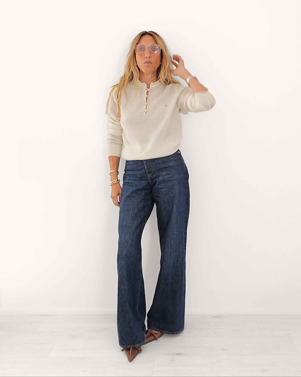 Kerri wearing Femme Ruffle Henley Sweater in Natural, styled with dark jeans, alternative view.