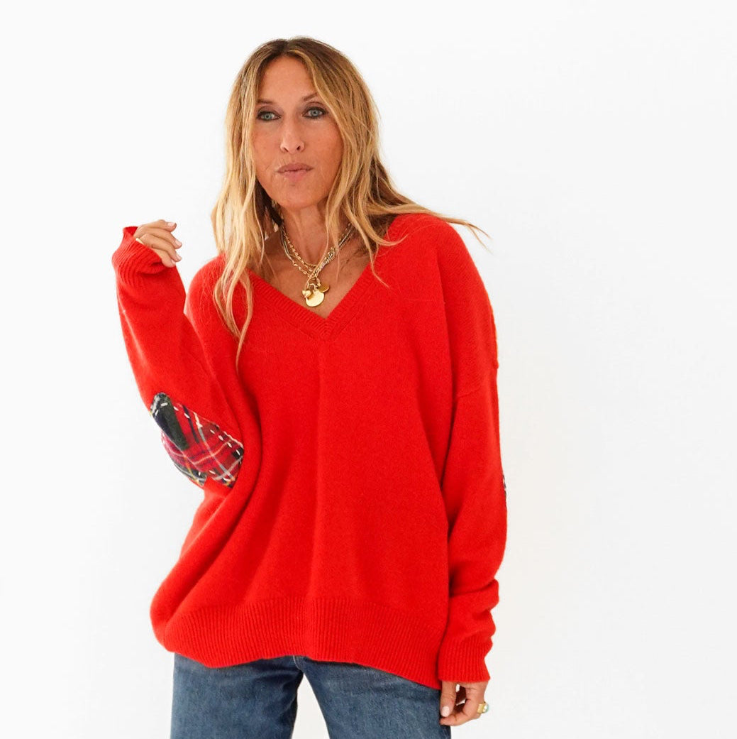 Kerri wearing the Frenchie Patchwork Sweater in red with tartan plaid heart elbow patches and jeans, front view