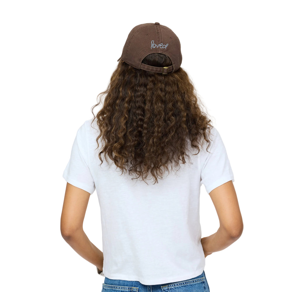 Back view of Kerri Rosenthal Imperfect Heart baseball cap in brown with blue 'loved' embroidery