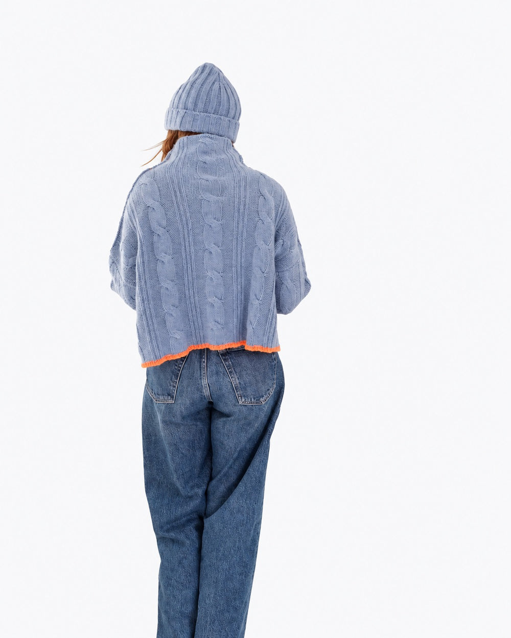 Kerri wearing the Hearth Sweater in blue with the Winter Beanie in blue and jeans, back view