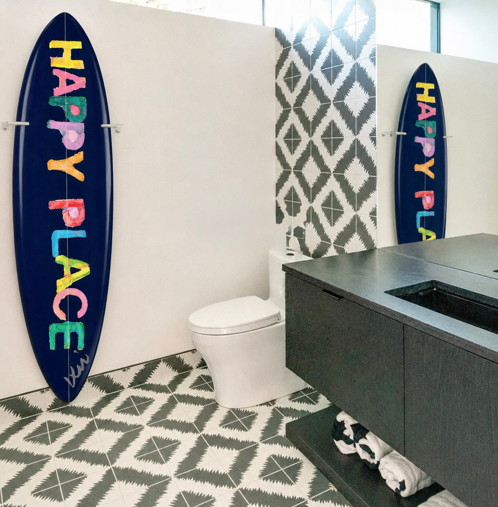 Bathroom with surfboards on the wall, one displaying 'Happy Place'.
