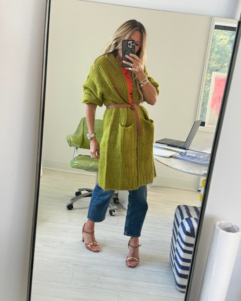 Kerri in her office wearing the Sienna duster tied at the waist with a brown leather belt, taking a selfie.