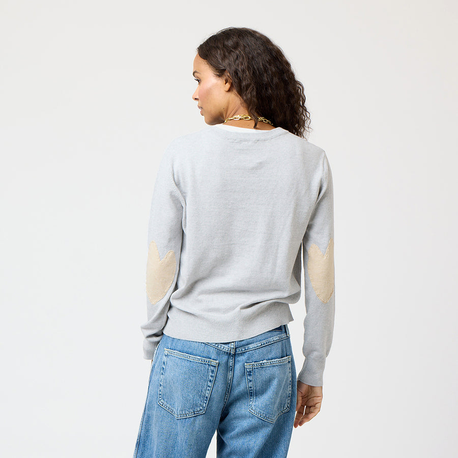 Grey patchwork crewneck sweater with imperfect heart patches on elbows in a soft cotton-cashmere blend. Cute women's sweaters by Kerri Rosenthal