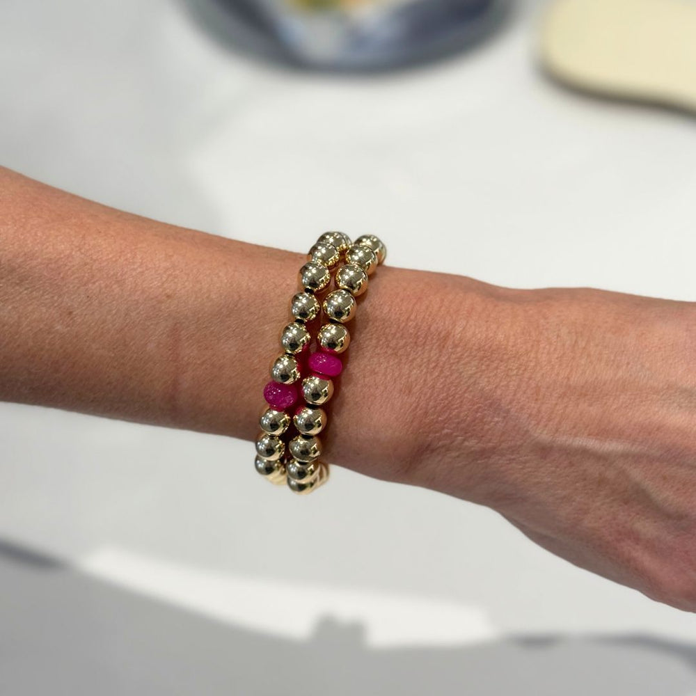 Gold Bead Bracelet brings a bright, beachy energy to your jewelry wardrobe with its mix of polished gold and pink natural stone rondels. Shop bracelets