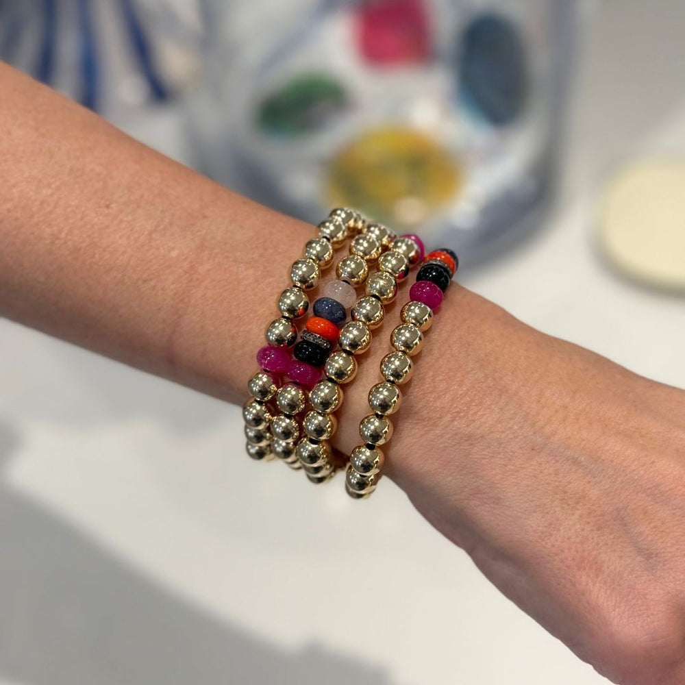 Gold Bead Bracelet brings a bright, beachy energy to your jewelry wardrobe with its mix of polished gold and pink natural stone rondels. Shop bracelets