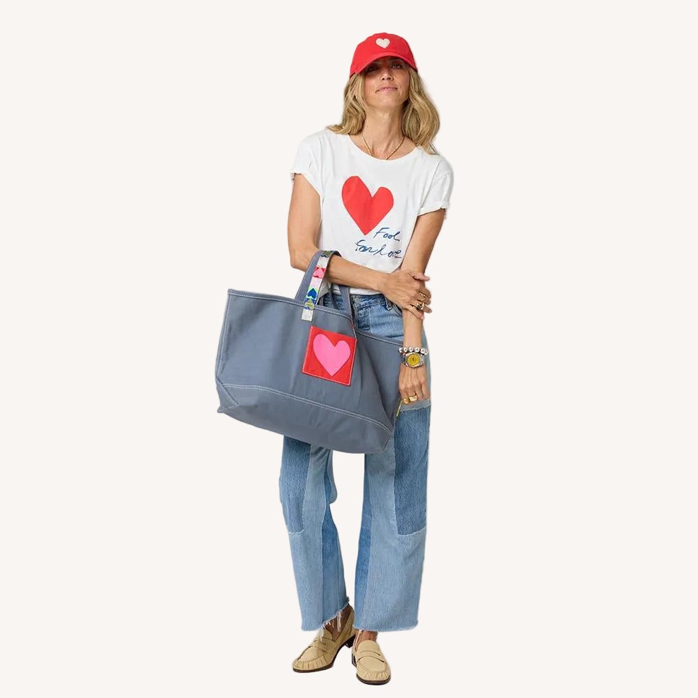 Suke white women's cotton tee with grey tote bag and red baseball cap hat by Kerri Rosenthal