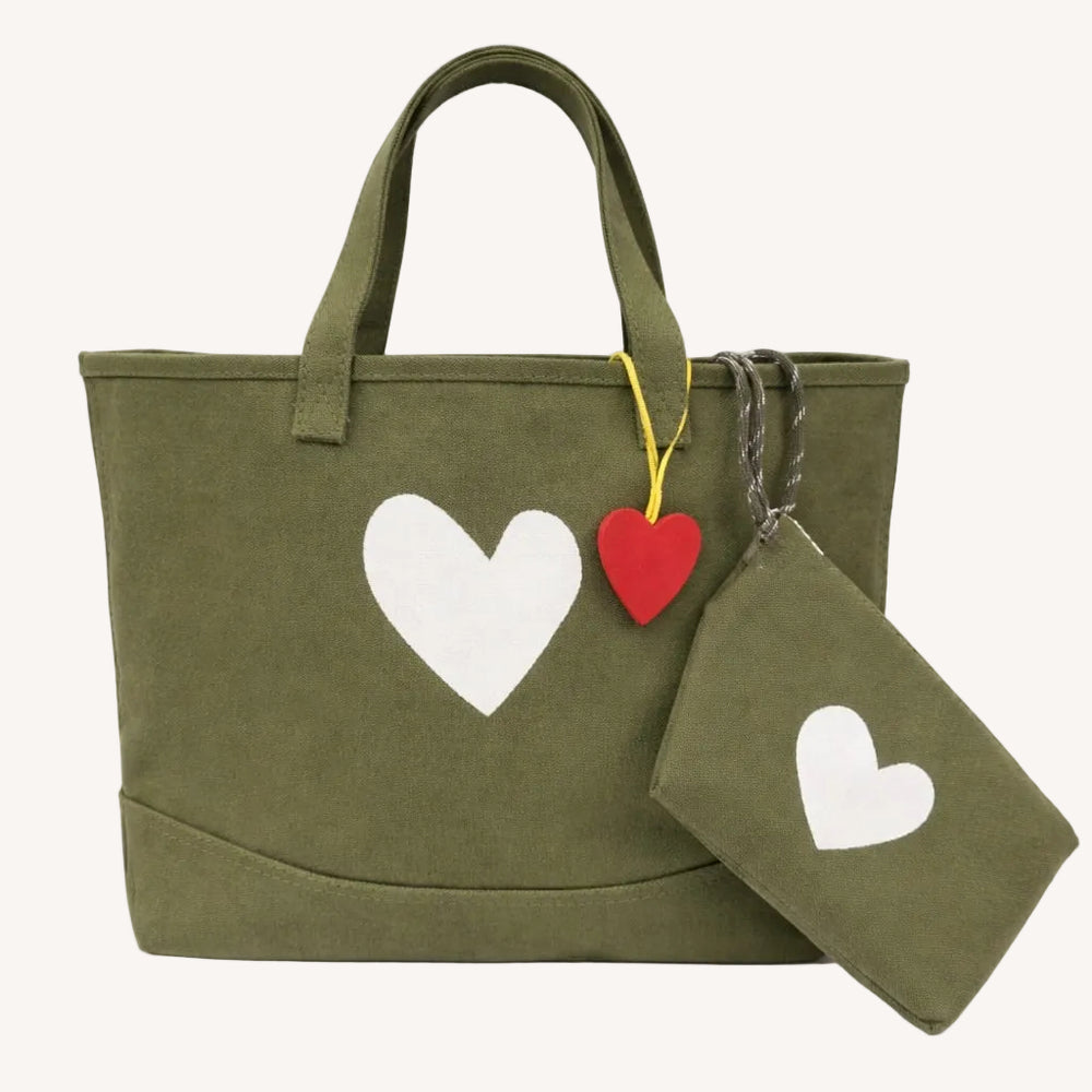 Olive green canvas tote bag with a white heart print and a red heart-shaped keychain charm with a matching pouch/wristlet