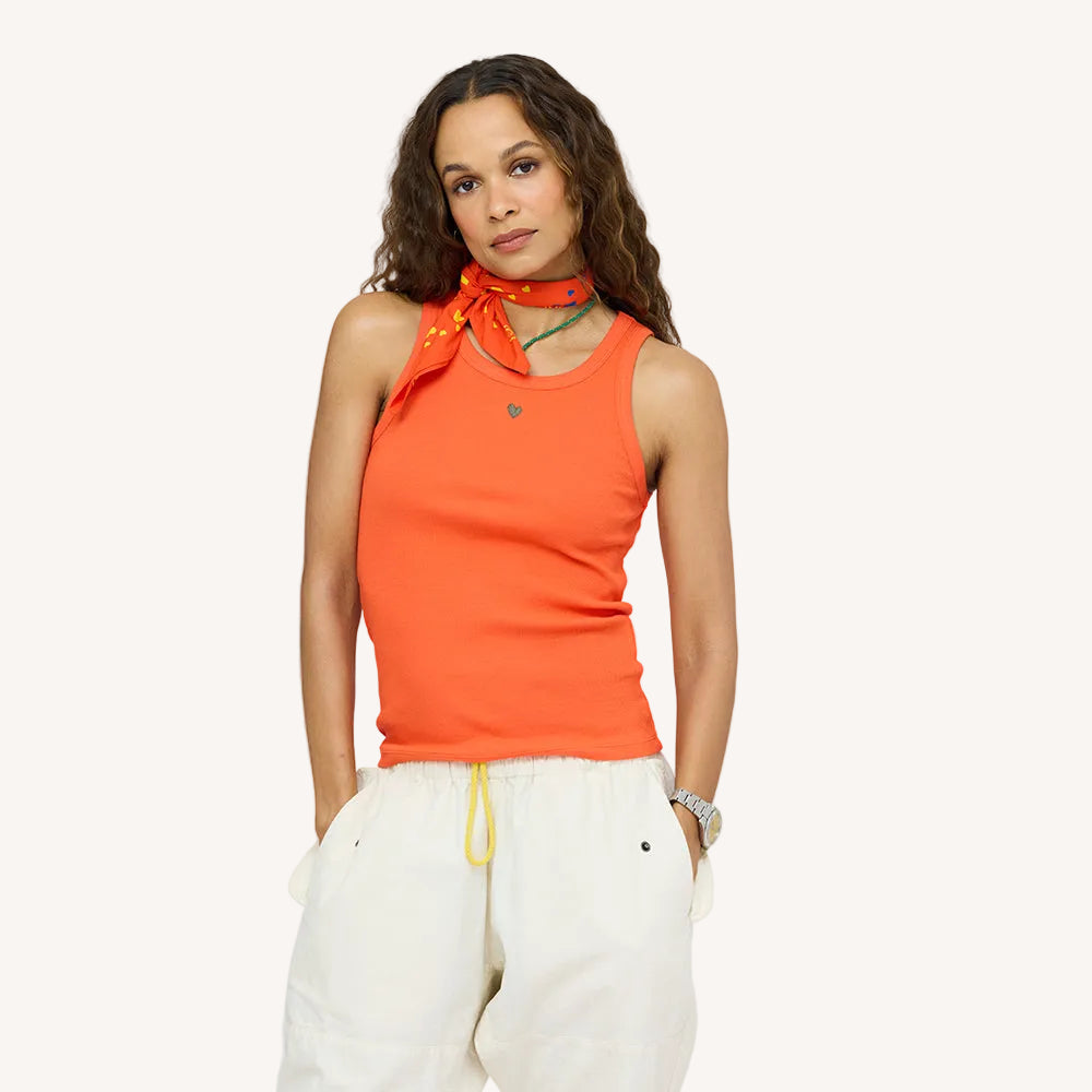 KR ribbed cotton blend red-orange tank top with a contrast embroidered heart and white love brigade pant with yellow drawstring and orange drippy heart bandana. Women's tank tops by Kerri Rosenthal