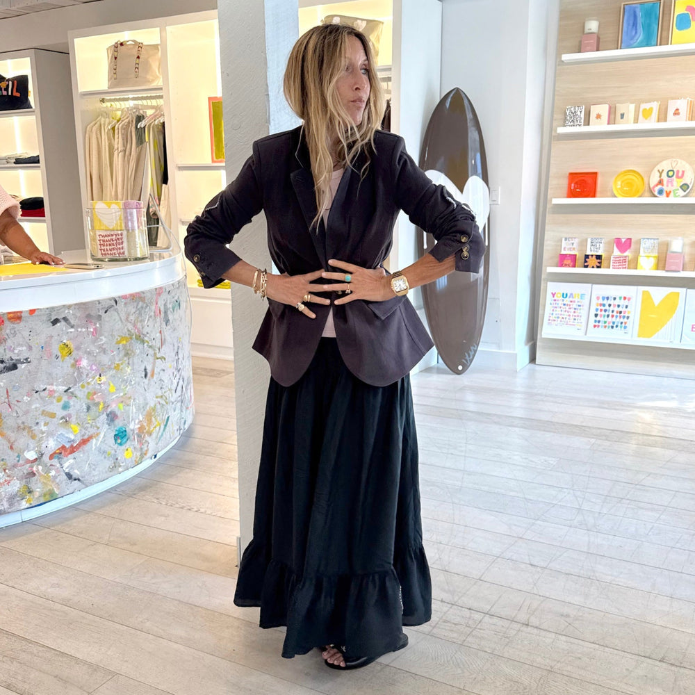 Kerri Rosenthal coal tailored blazer styled over black tiered maxi skirt, boutique lifestyle shot. Shop Kerri Rosenthal blazers